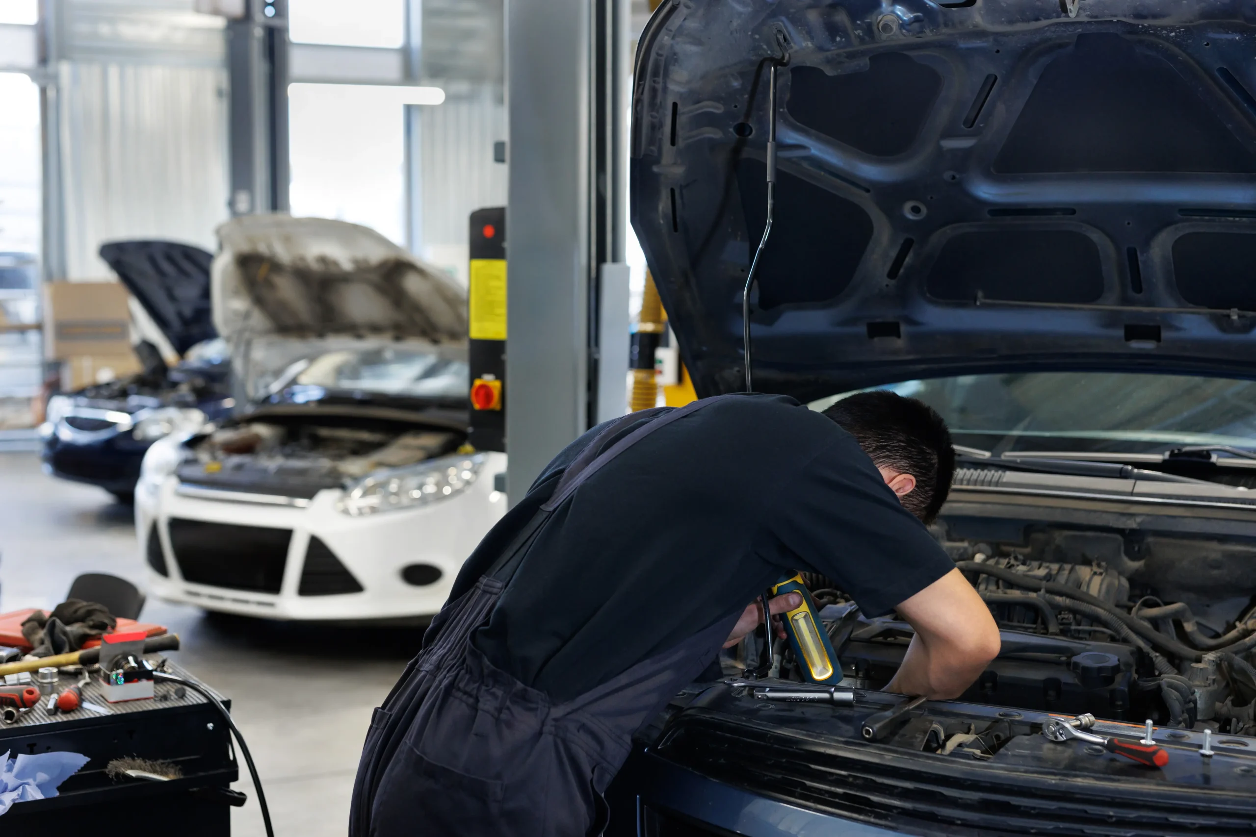 close-up-of-a-worker-a-repairman-repairing-a-car-2025-01-10-20-40-18-utc