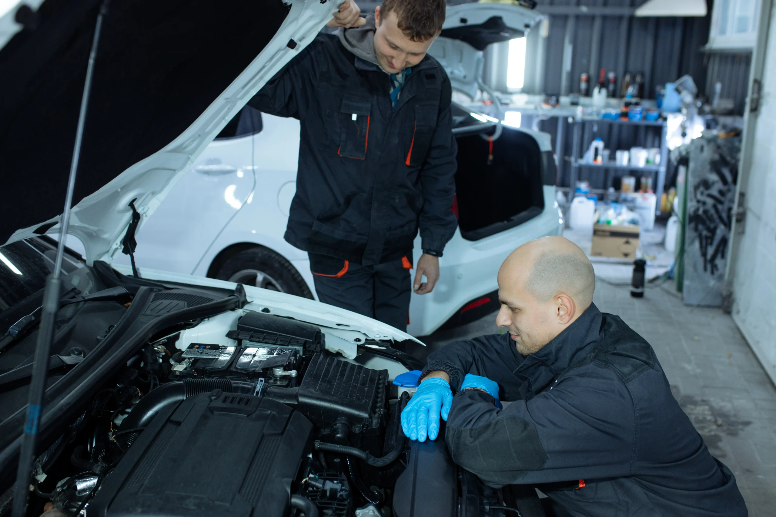 mechanic-men-with-wrench-repairing-car-at-workshop-2025-03-09-11-19-08-utc